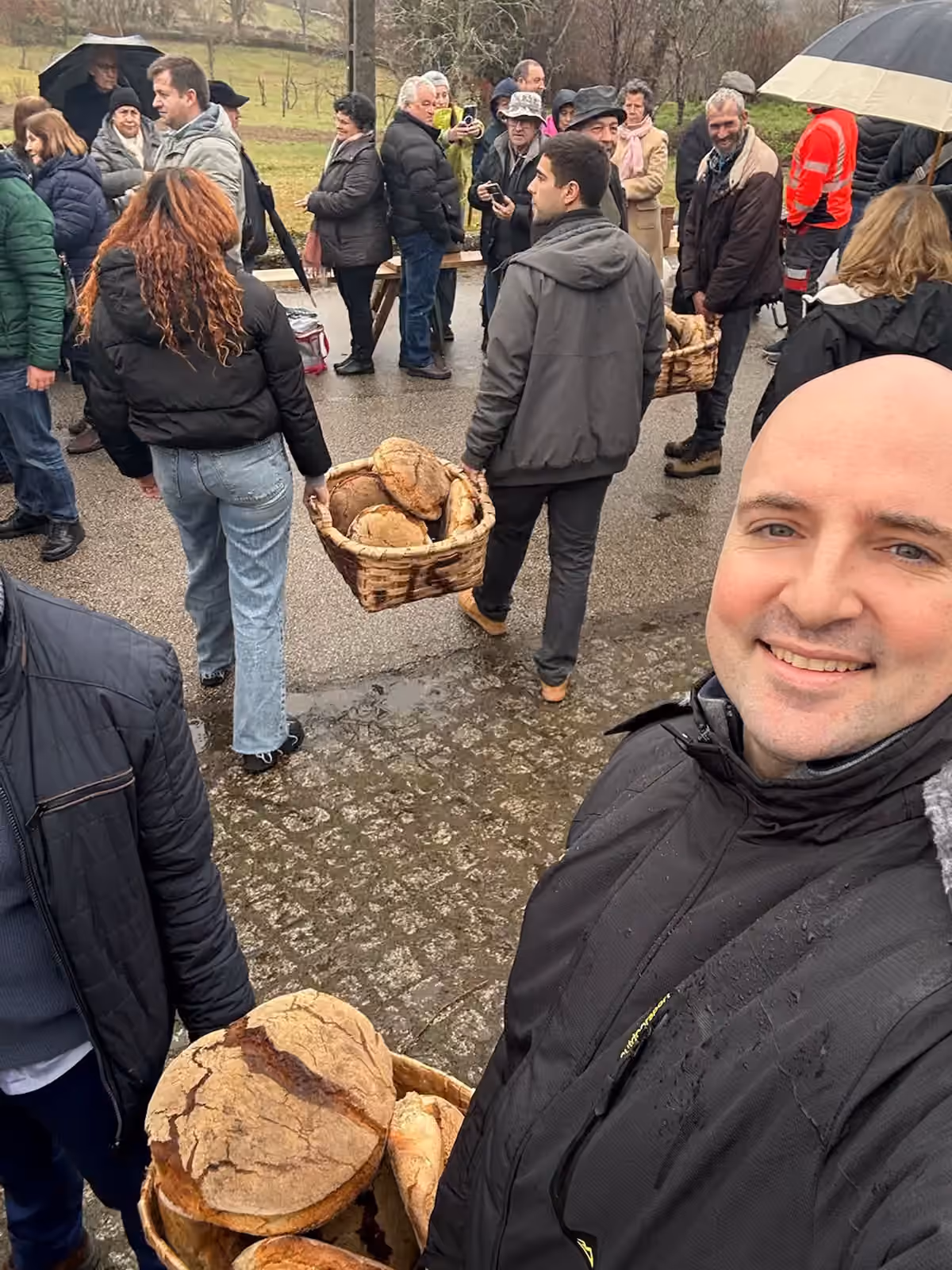 Thomas Gaultier among residents at a village gathering on a wet winter morning in rural Portugal